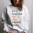 Load image into Gallery viewer, "It's a Beautiful Day to Read Banned Books" Reader's Sweatshirt